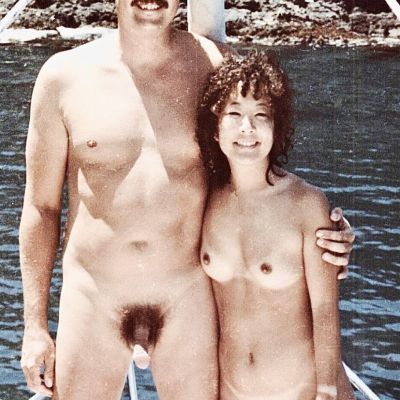 Naked nudist sailing with friends
